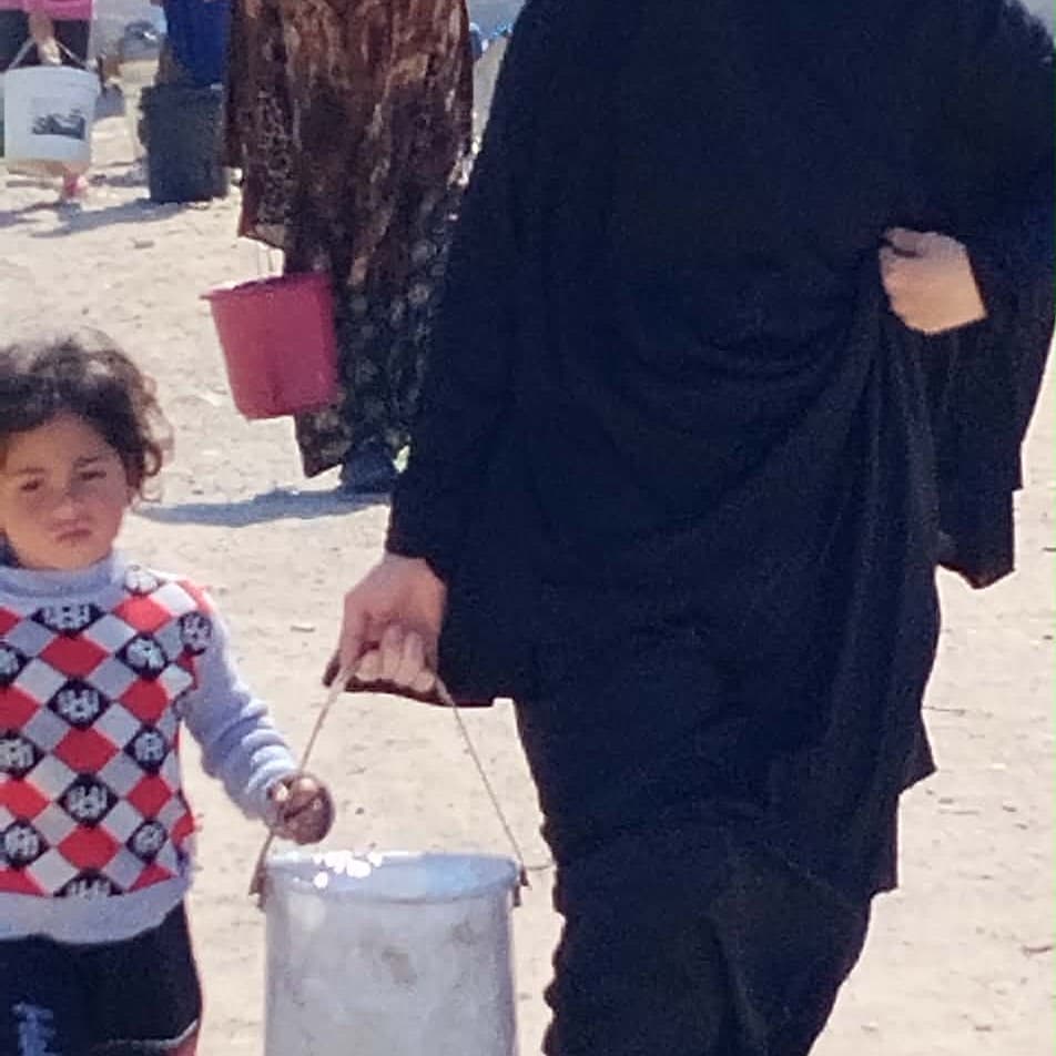 Families in Gaza collecting clean water filtered by Blue Filter