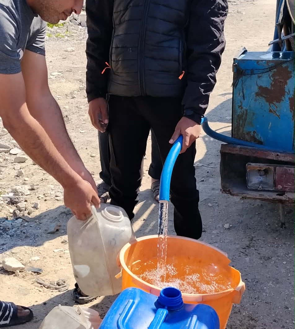 Clean water filling a container at a Blue Filter distribution point
